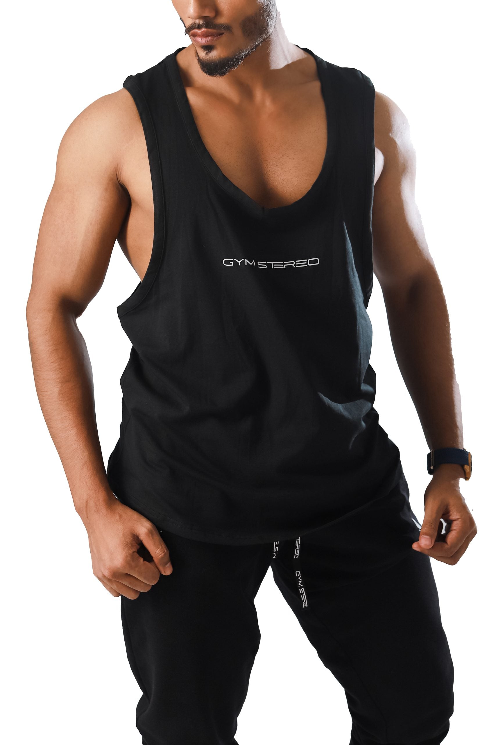 A man wearing a black sleeveless tank top with the logo 'GS26' visible on the chest area.